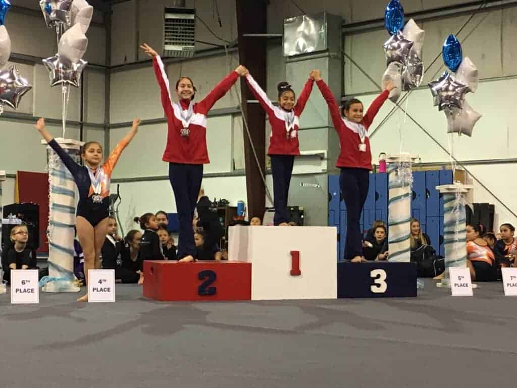 Photo - The All About Dance and Gymanstics Level 3 gymnasts take the top three spots on the podium during a meet in Visalia.