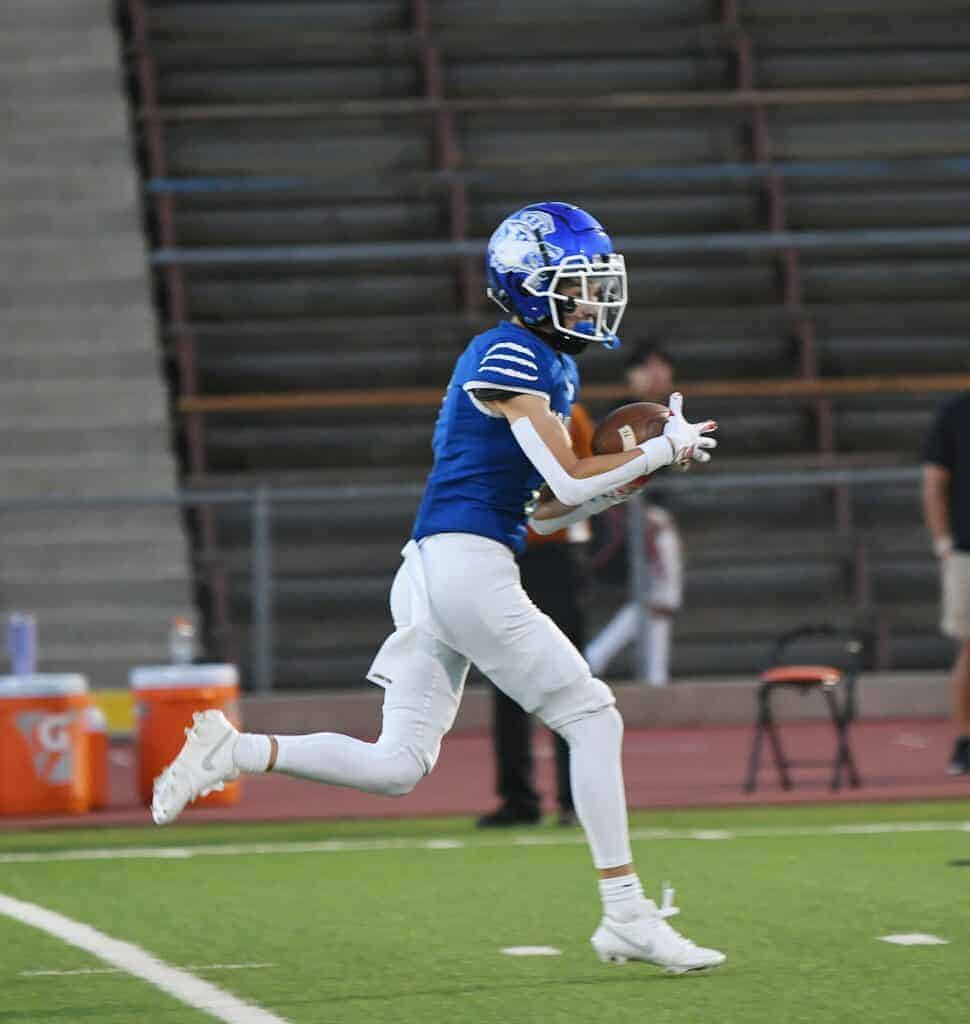 Photo - Madera’s Ty Davis hauls in a 36-yard pass on the first Coyote play of Friday’s 49-24 victory over Selma.