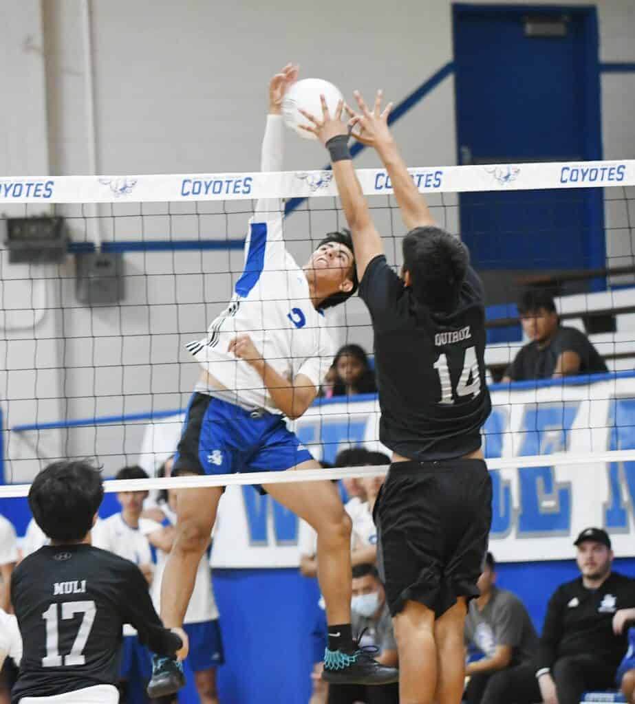 Photo - Madera’s Angel Leon tries to get a hit past the block of Madera South’s Flavio Quiroz during Thursday’s three-set sweep over the cross-town rivals in Joe Flores Gym.