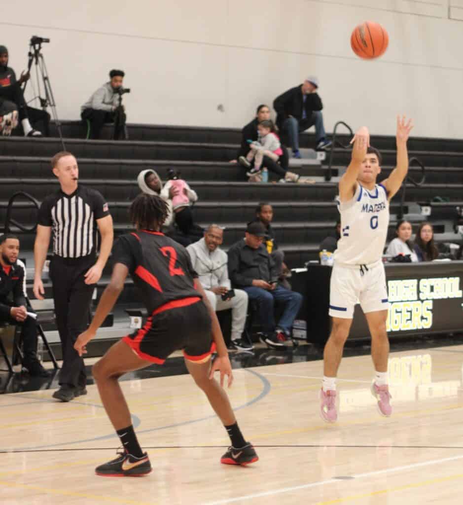 Photo - Madera’s Elias Torres rises up for a 3-pointer during Friday’s loss to North of Bakersfield at the MLK Showdown at Edison. Torres led the Coyotes with 11 points. 
