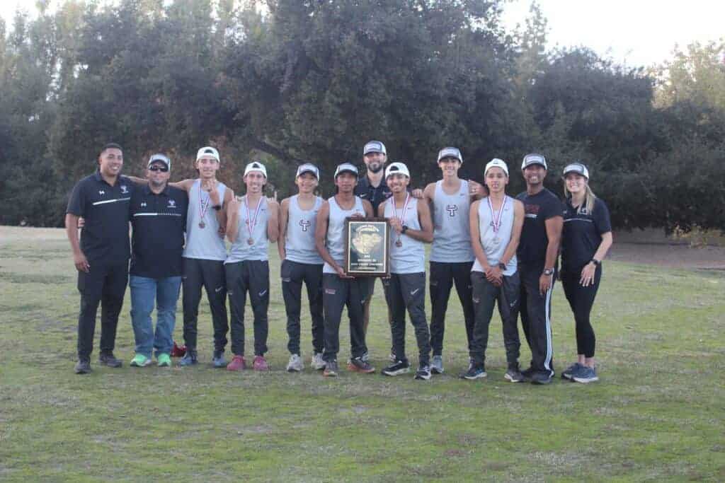 Photo - The Matilda Torres Toros boys cross country team celebrates winning a Div. III Central Section championship with the plaque and coaches after Thursday’s victory at Woodward Park.