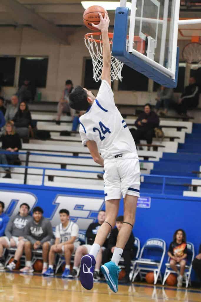 Photo - Madera’s Stevie Estrada rises up to put down one of two dunks in Friday’s loss to Bullard. 