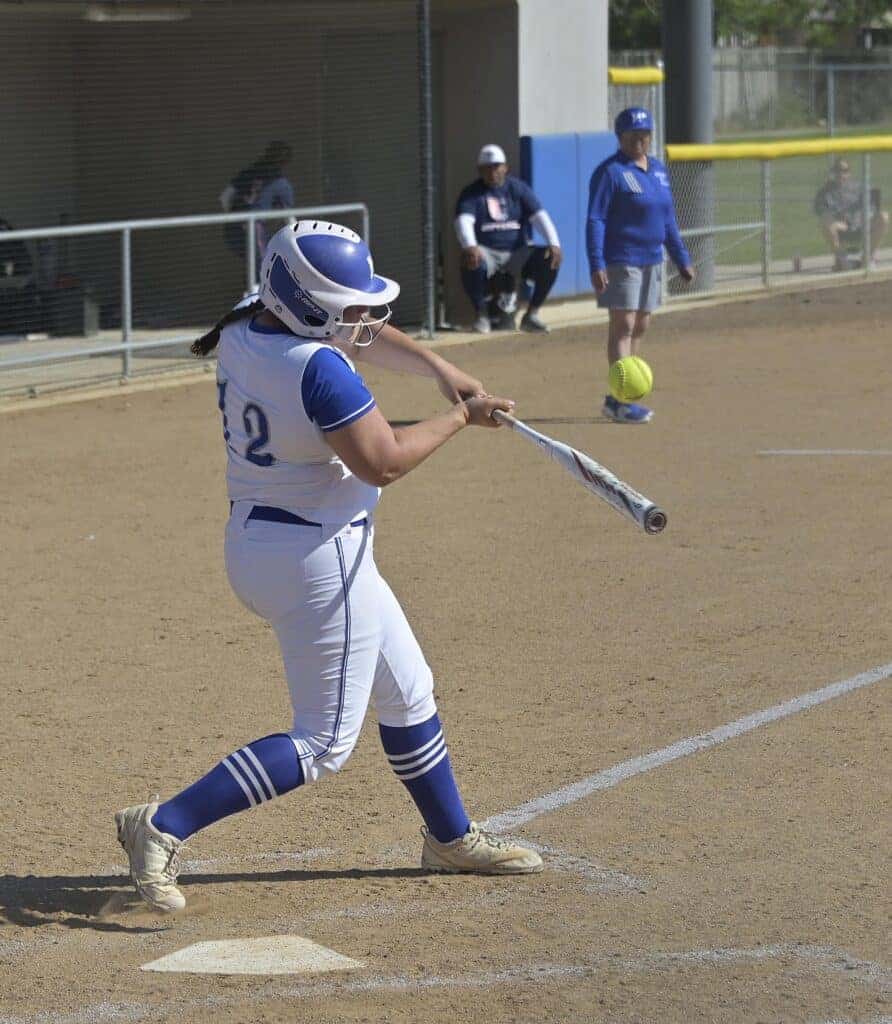 Photo - Madera’s Kylie Powell hits a fly ball to center to drive in a third inning run during Friday’s 16-2 rout of Justin Garza. Powell had two hits and drove in three runs in the game. 