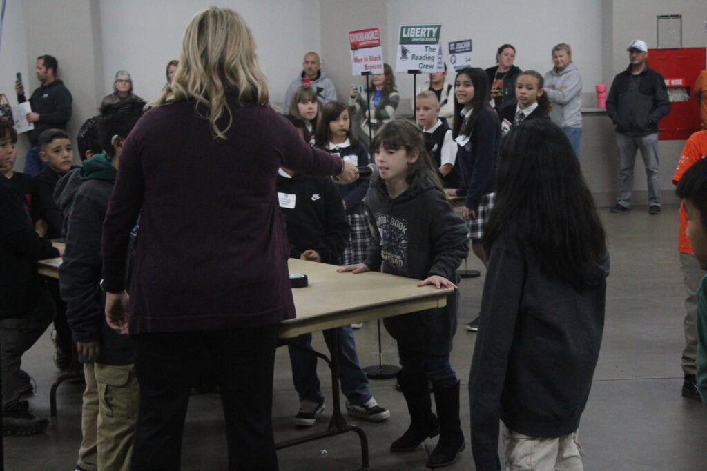 Photo of Leia Garcia, a third grader from Liberty Charter School, answers a question during the Book Buzz part of the Battle of the Books on December 10. She helped Liberty win the Book Buzz competition and place third overall.