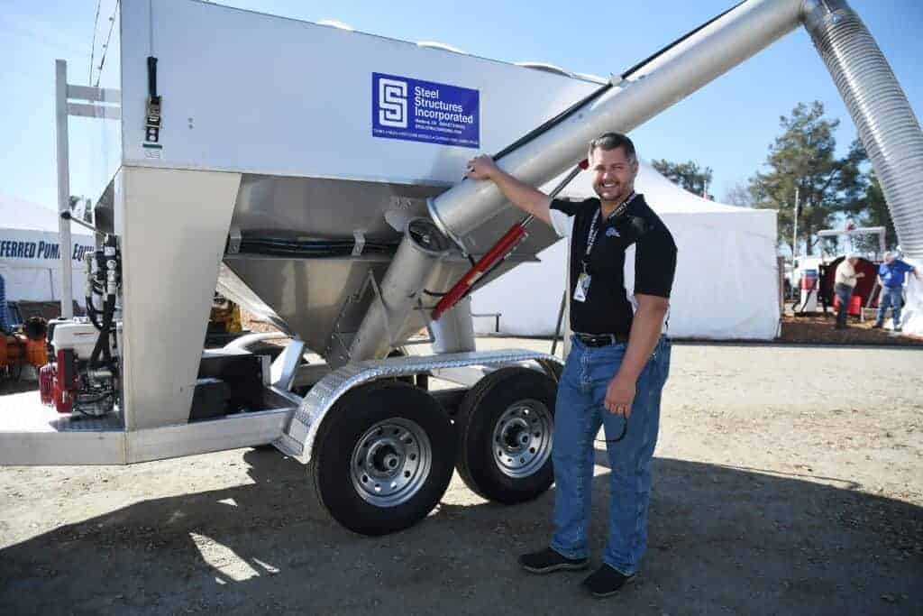 Photo - Steel Structures owner Dan Riley stands next to one of the farm equipment machines his company builds. He and Steel Structures will receive the Crystal Tower award this month by Madera County Compact.