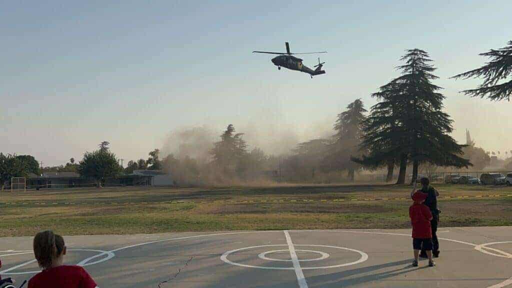 Photo - A Black Hawk helicopter makes its way to land in at Fuller School on Friday for the Patriots Day Assembly.