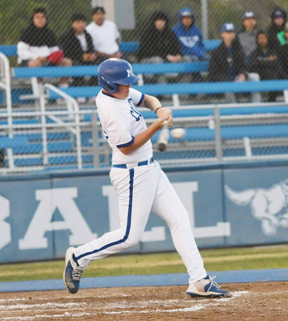 Photo - Madera’s Benji Molina gets handcuffed on a pitch, but reached on an error. Molina later homered for his first hit of the season in Monday’s 15-5 victory over Liberty.
