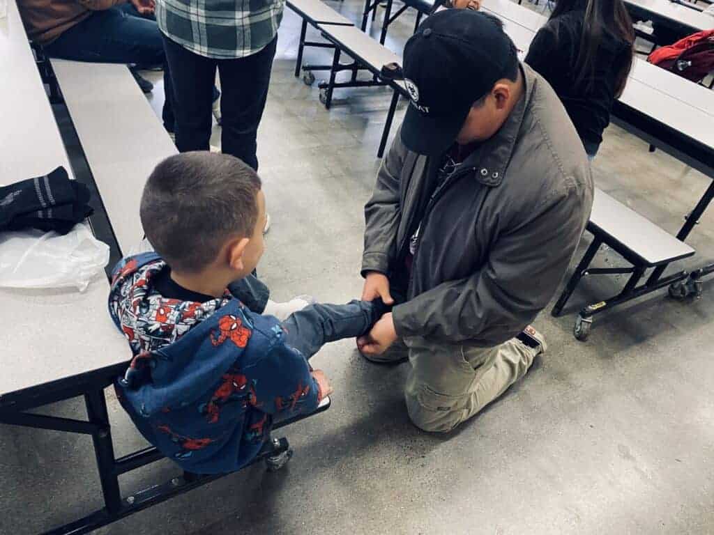 Photo - Madera Leo Club members pass out shoes at Pershing Elementary, one of many schools they visit.