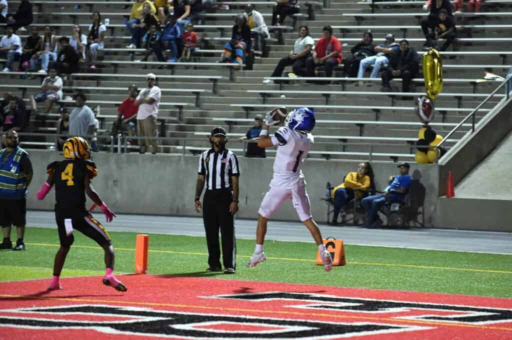 Photo - Madera’s Michael Pedro makes the catch near the sideline in the end zone during Friday’s victory over the Edison Tigers.