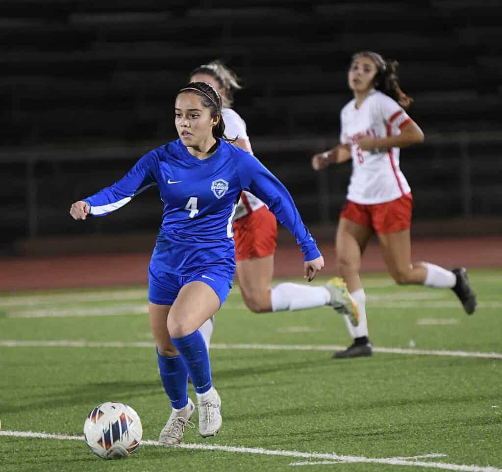 Photo - Madera’s Isabel Rodriguez looks for an open teammate during Friday’s match with San Joaquin Memorial. Rodriguez scored Madera’s lone goal in a 4-1 loss in Memorial Stadium.