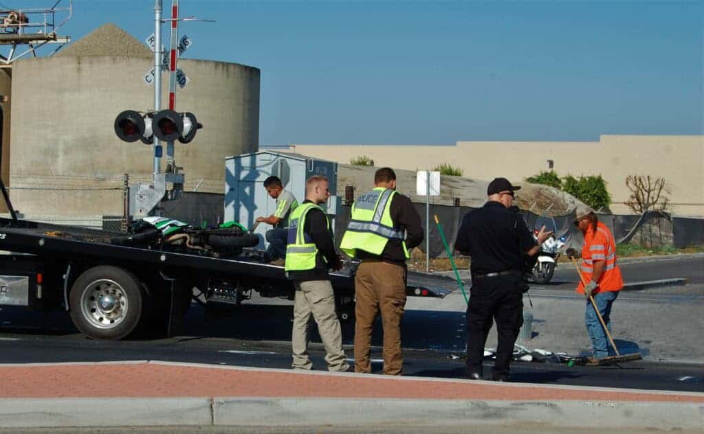 Photo - Police collect evidence at the scene of a fatal motorcycle collision Thursday morning on Pine Street near Howard Road. Police have arrested the other driver on charges of felony vehicular manslaughter, and allege he was under the influence of cannabis at the time of the collision.