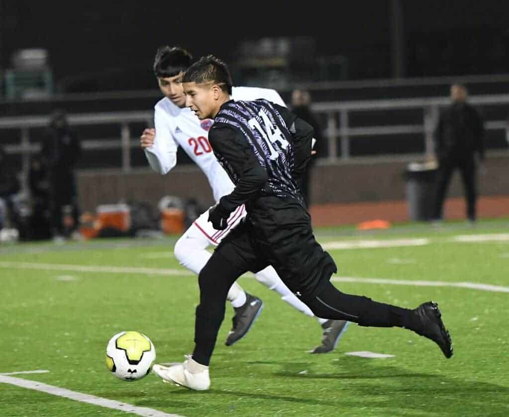 Photo - Madera South’s David Vasquez works to get in front of a Sanger defender during Friday’s tie with the Apaches.