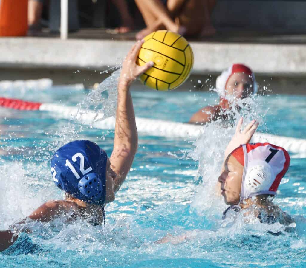 Photo - Madera’s Bailey Hansen sends a shot over the Clovis East goalie to score one of her two goals in a 9-6 loss to the Timberwolves.