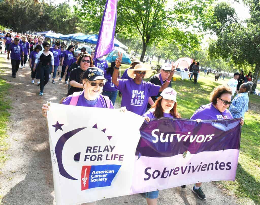 Photo - Cancer survivors kick of the annual Relay For Life event in 2019 at Lions Town and Country Park as they carry banners and take the first traditional and honorary lap.