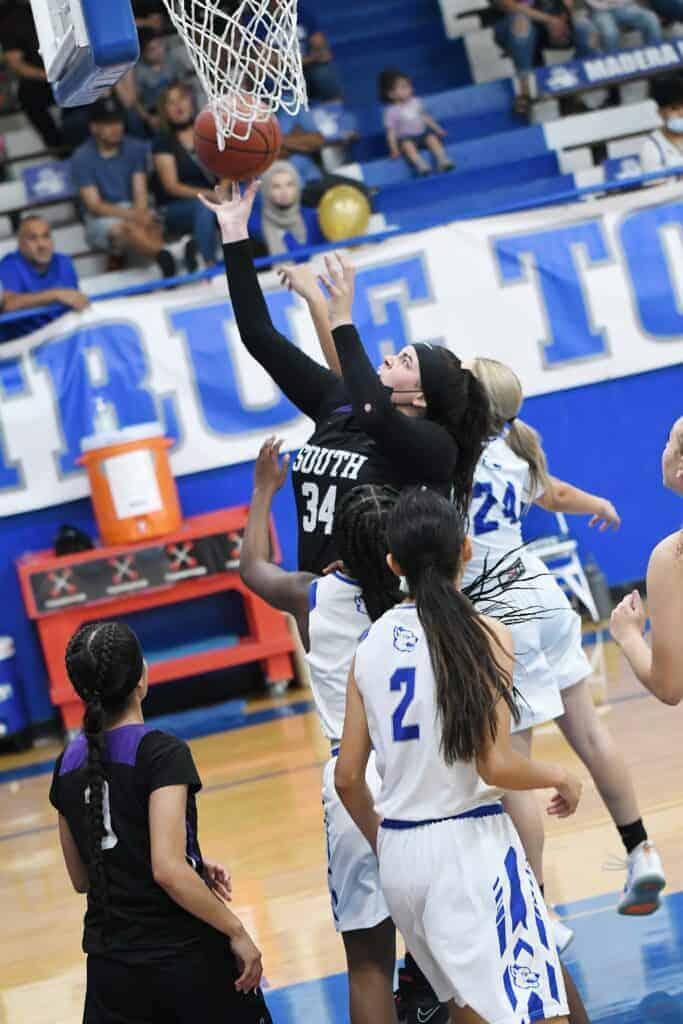 Photo - Madera South’s Arelis Chavez powers her way to the hoop to score two of her 12 points. She recorded a double-double against the Coyotes with 12 rebounds, including seven on the offensive glass.