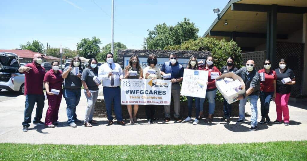 Photo - Representatives from World Financial Group gather with staff members of Madera Rehabilitation & Nursing Center for a photo op after donating 2,000 masks to the facility on Sunday.