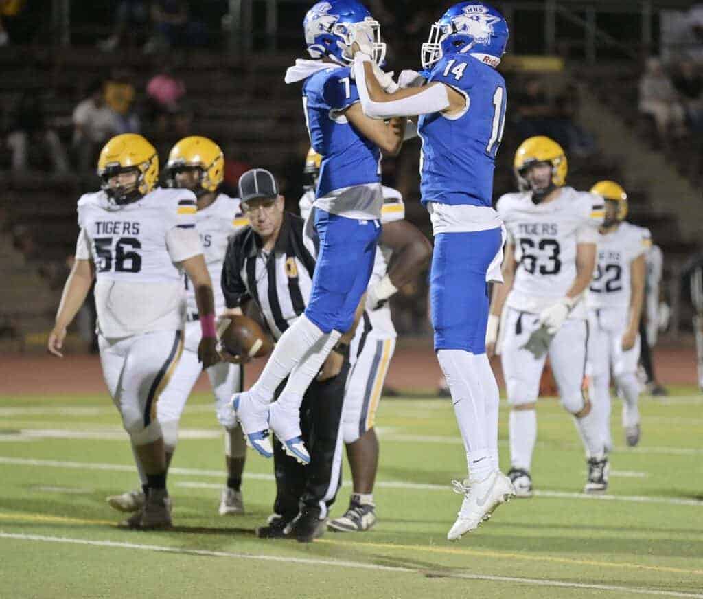 Photo - Madera receiver Emanuel Soliz (14) celebrates with Kenji Tiscareno (7) after Tiscareno’s second quarter touchdown during Friday’s victory over Edison.