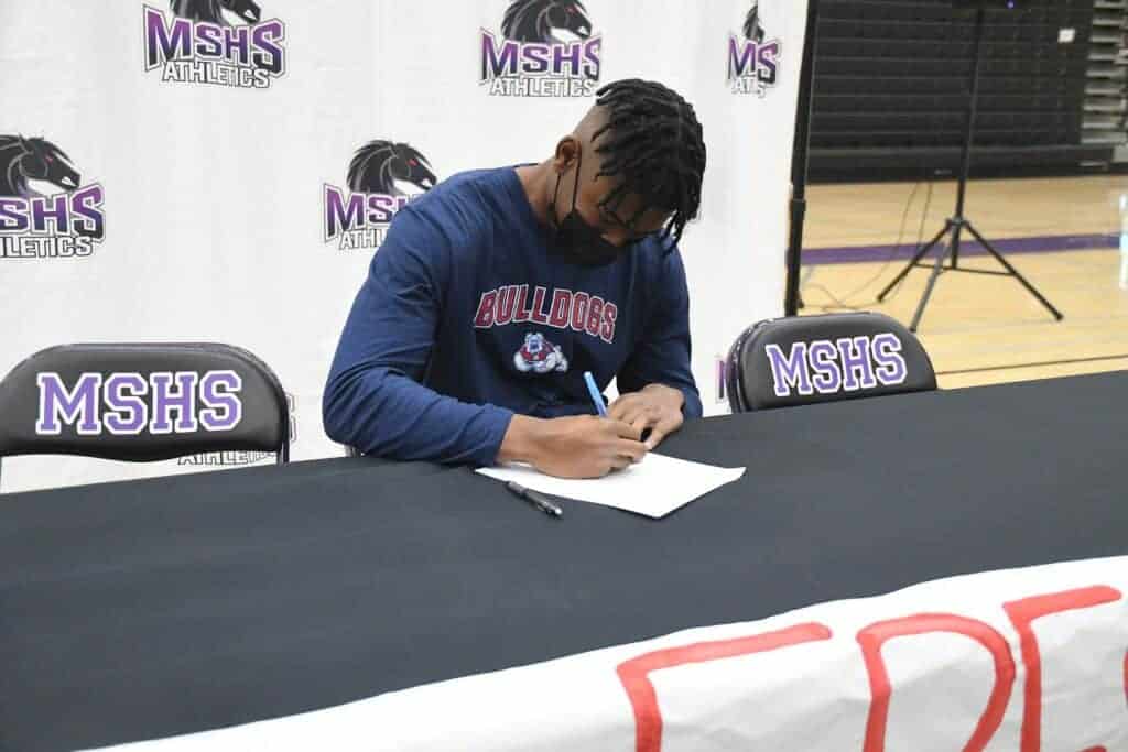 Photo - Madera South baseball player Murf Gray officially signs his National Letter of Intent to play next season at Fresno State during a signing ceremony on Dec. 3.