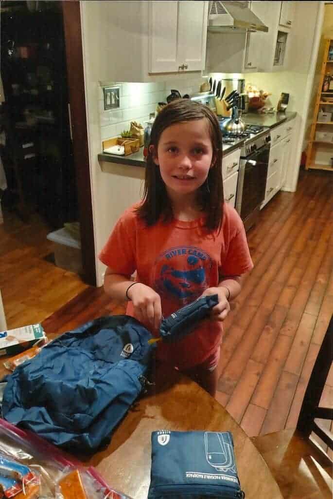 Photo - Hazel Allinder fills up backpacks she intends to hand out to those less fortunate. She made four backpacks and has handed out two.