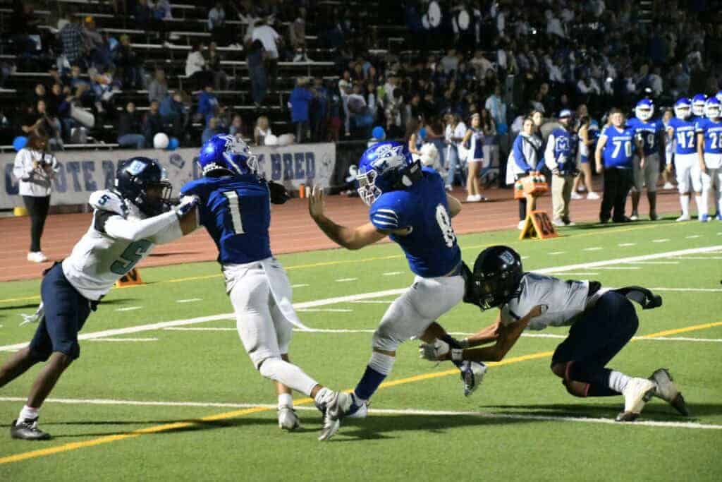 Photo - Madera’s Zach Prince breaks through a tackle to score Madera’s lone touchdown in Friday’s loss to the Bullard Knights.