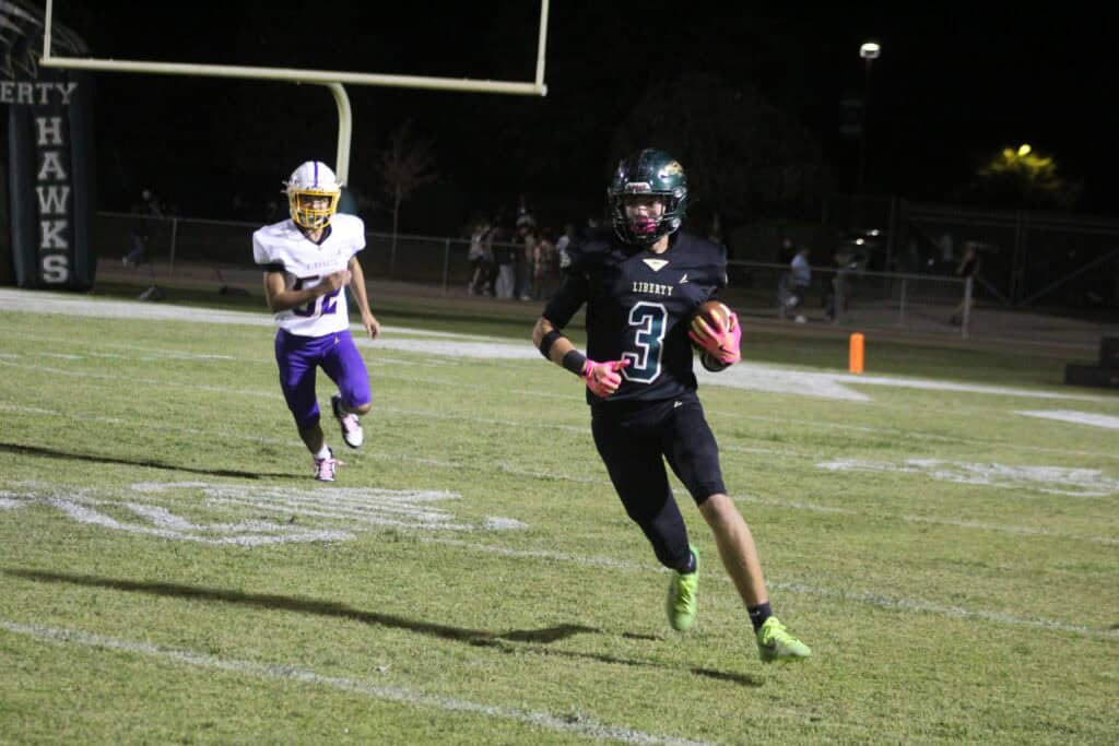 Photo - Liberty’s Brody Rollins finds open running room for one of his two 20-plus yard runs during Friday’s victory over Minarets. Rollins came off the bench to rush for 101 yards and a touchdown. 
