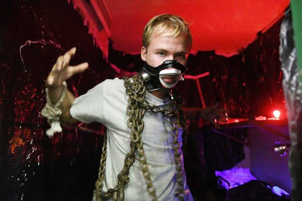 Photo - Michael Fisher gets a little practice at scaring people as he is chained in a cell at the venue.