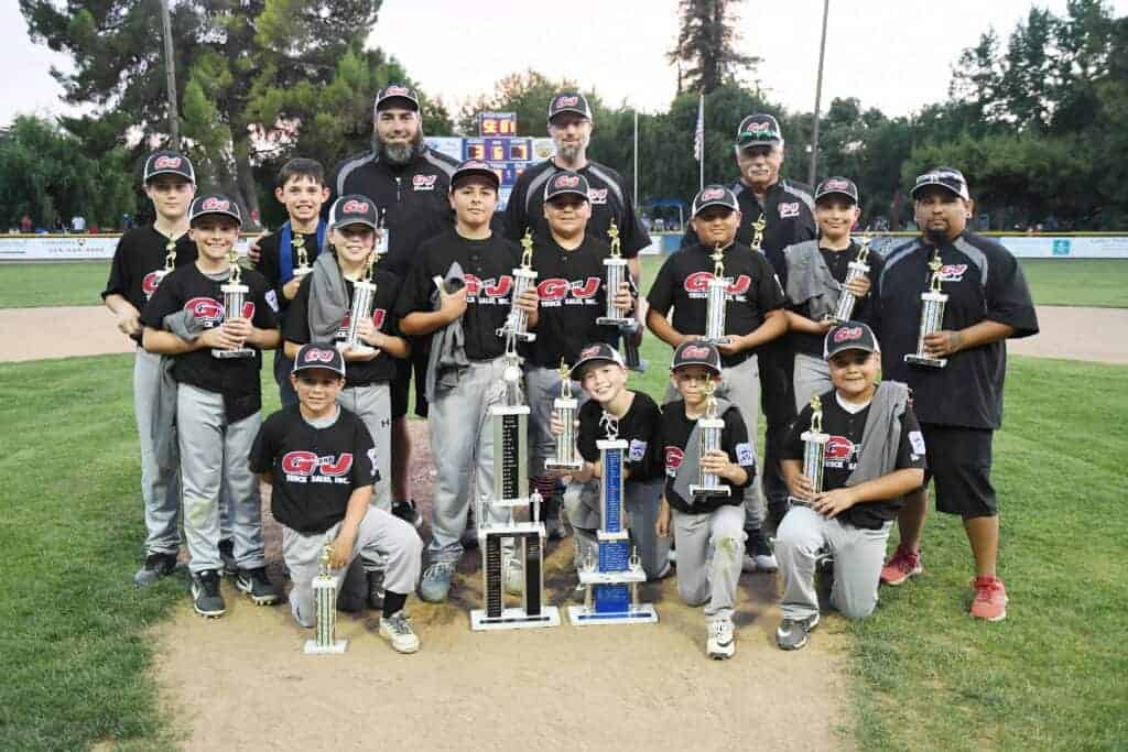 Photo - Madera National Little League champion G&J Trucking Sales celebrates a 7-3 defeat of Madera American Little League champion Lee’s Concrete to win the Madera City Championship on Saturday.