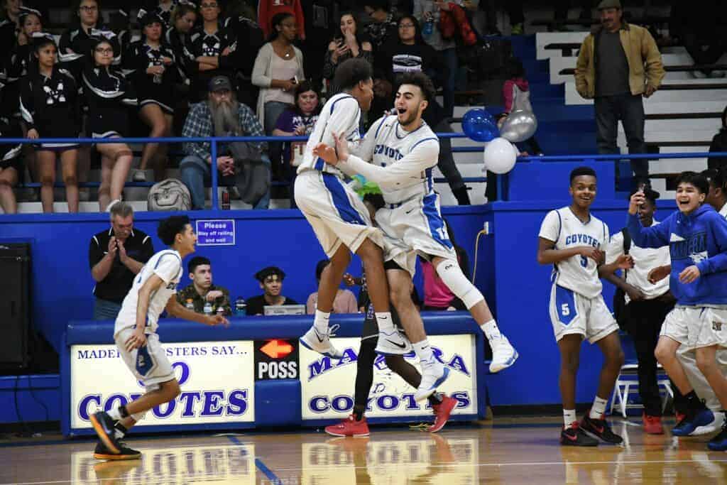 Photo - Madera seniors K’Veon Jones, left, and Ali Escheik celebrate Tuesday’s upset victory over the Madera South Stallions. It was Madera’s first league win and first win over Madera South in three years.