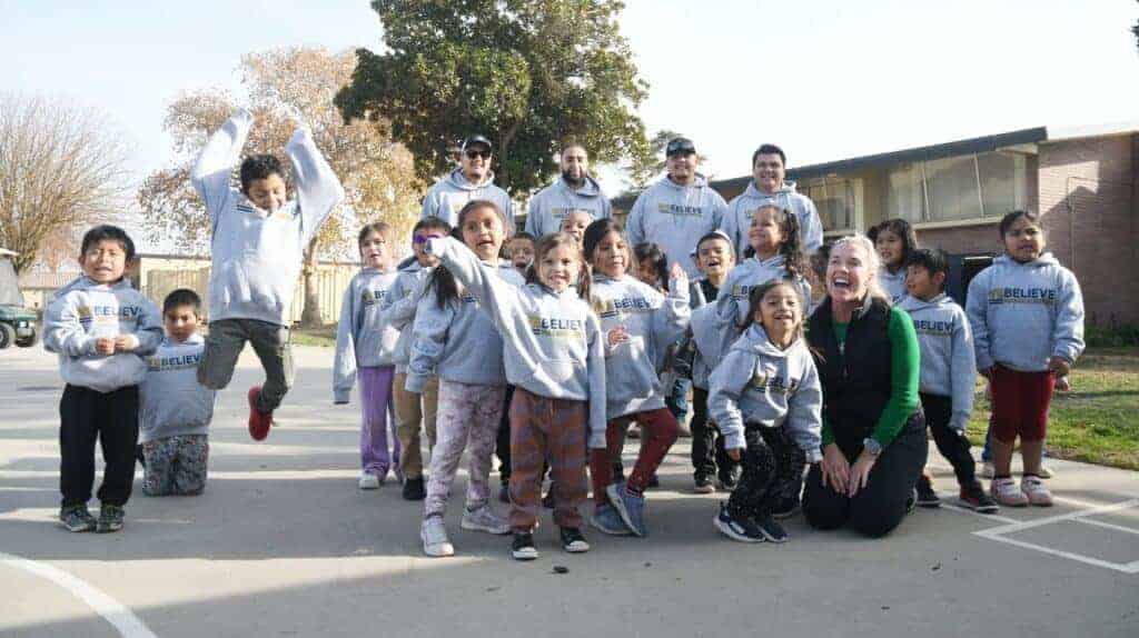 Photo - Sierra Vista Elementary School students show their enthusiasm after receiving sweaters on Thursday.