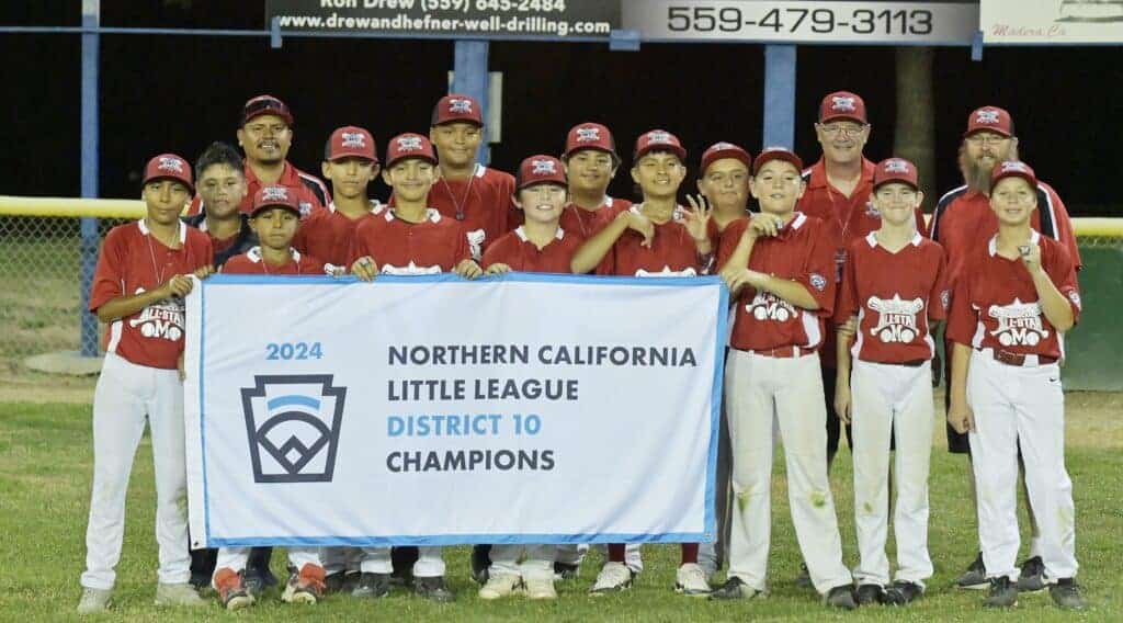 Photo - The Madera American Little League 12-year-old All-Star team celebrates a 7-3 victory over Madera National to claim the District 10 championship. Next up are Section Championships beginning Wednesday in Corcoran. 