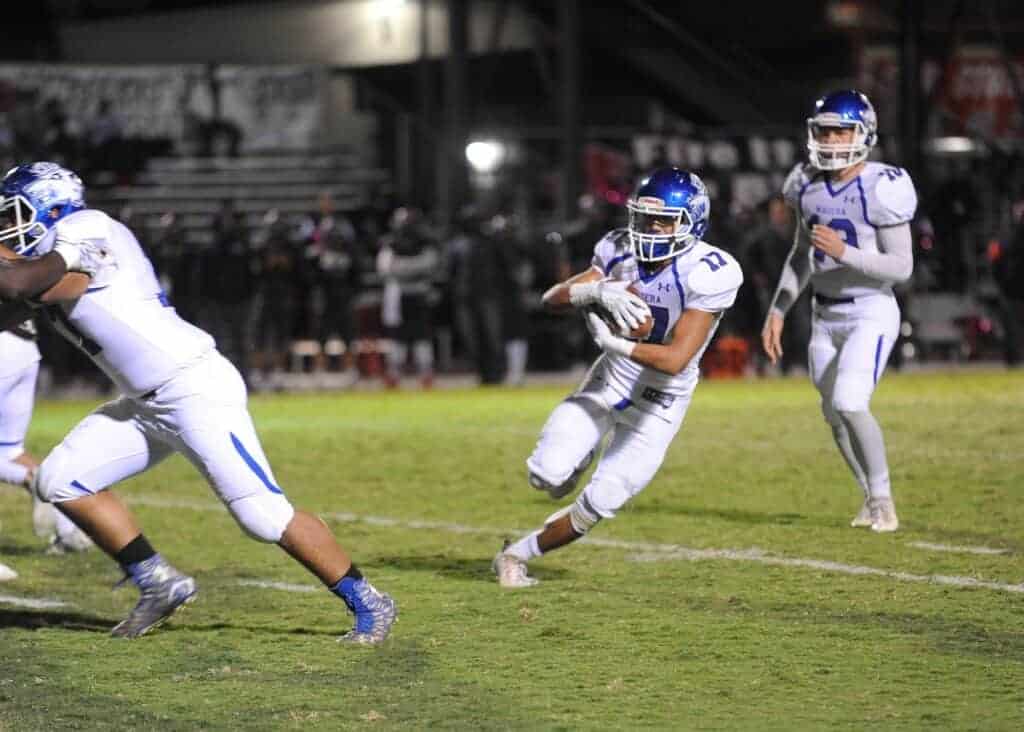 Photo - Madera’s Joseph Saldivar tries to find running room during Friday’s 54-20 loss to the San Joaquin Memorial Panthers. Salvidar scored two of the Coyotes’ three touchdowns.