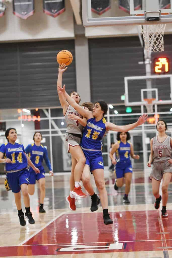 Photo - Matilda Torres’ Sabrina Cerrillo tries to drive around Tanquillity’s Jasmine Navarro for a bucket in Tuesday’s playoff victory. Cerrillo led the Toros with 19 points to go with eight steals.