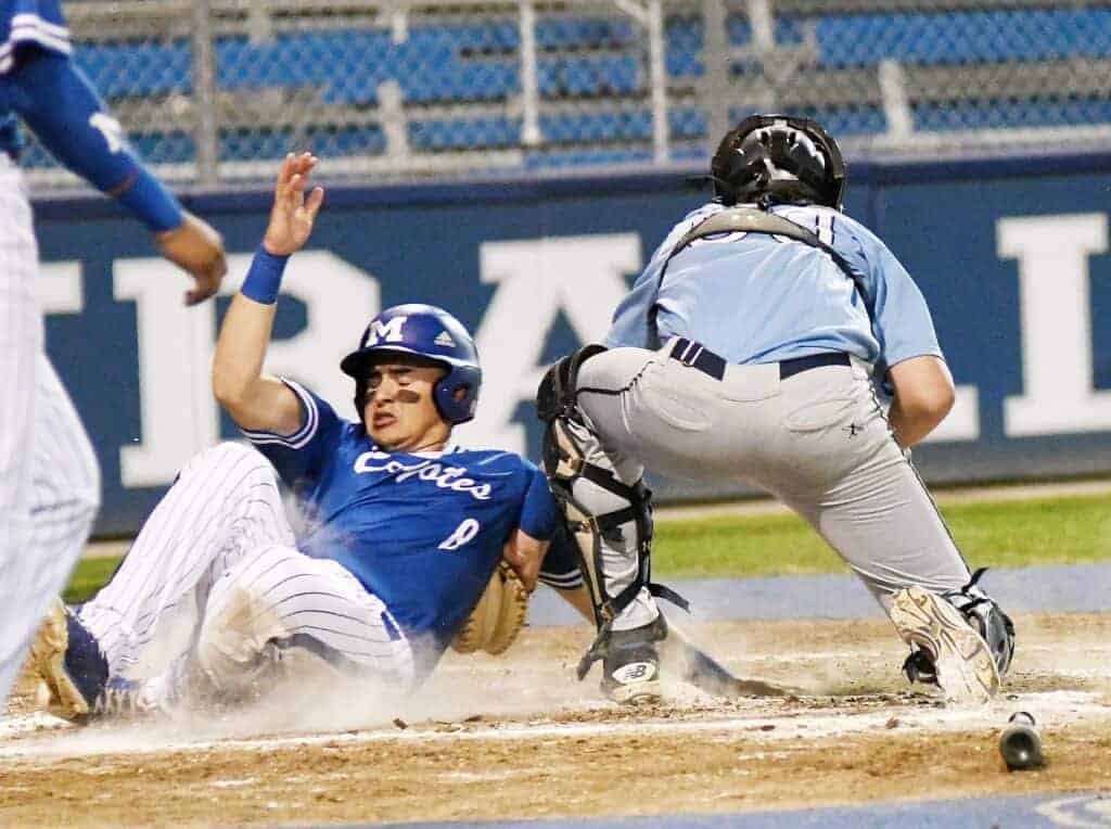 Photo - Madera’s Christian Chavira slides in safely to score the Coyotes’ go-ahead run during a 25-7 win over Central Valley Christian.
