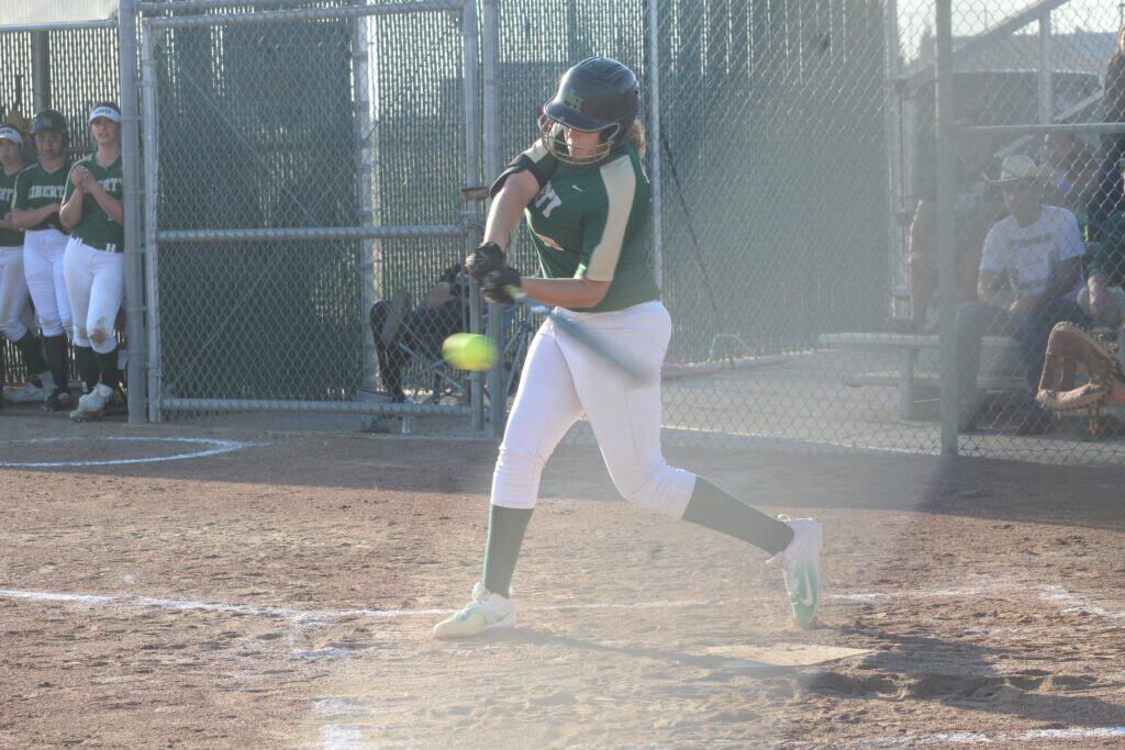 Photo - Liberty pitcher Sarah Shevenell rips a double to left field to clear the bases during a 10-0 victory over Golden West on Tuesday. Shevenell drove in four runs and threw three no-hit innings in the win.