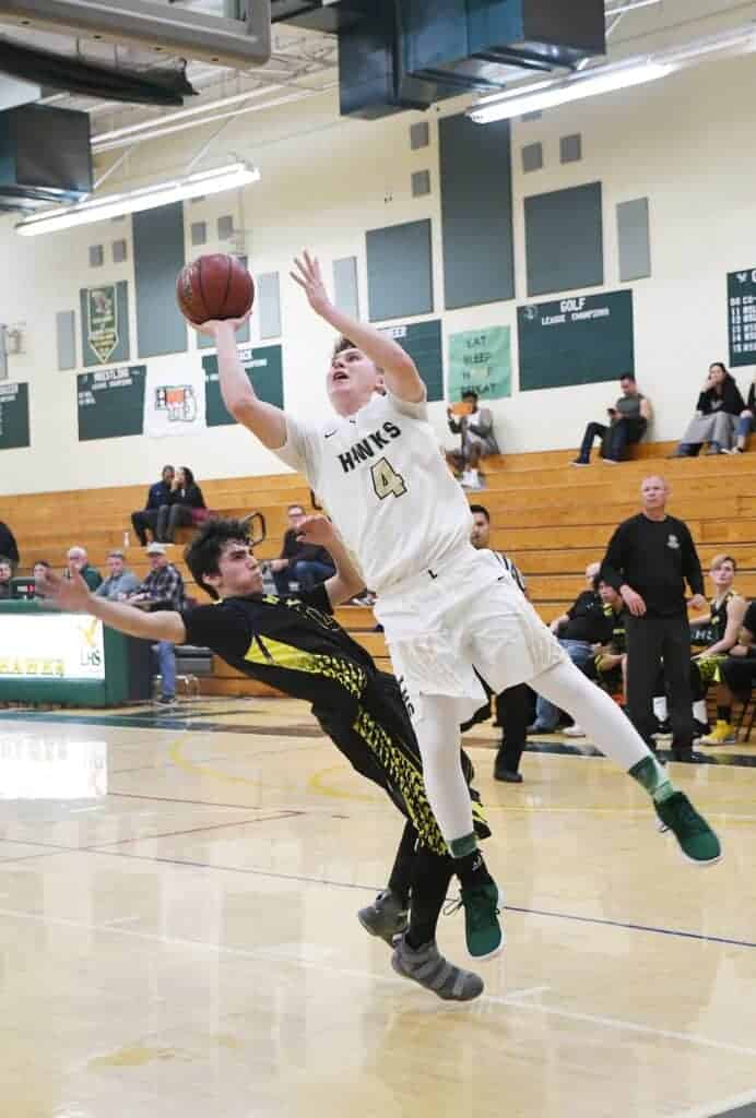 Photo - Liberty's Nathanael Samarin drives to the hoop during the Hawks' victory over Sierra on Friday night during the Liberty Hawks Classic.