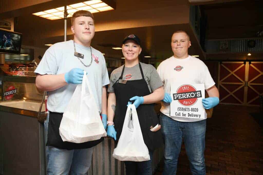 Photo - Perko’s Cafe & Grill is open for takeout or delivery, within a 10-mile radius. They are open from 6 a.m.-9 p.m. daily and stop deliveries at 8:30 p.m. For delivery or to place an order call: 675-8020. From left are son Tommy, owner Kelly Molina, and son Benji.