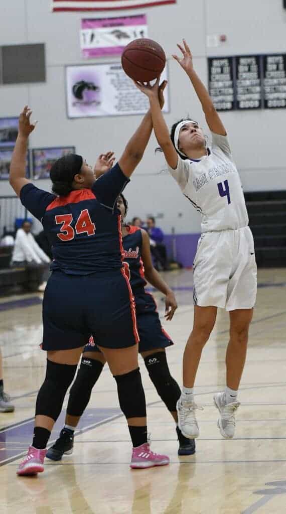 Photo - Madera South’s Aleecia Rosel drives to the rim for two of her game-high 25 points.