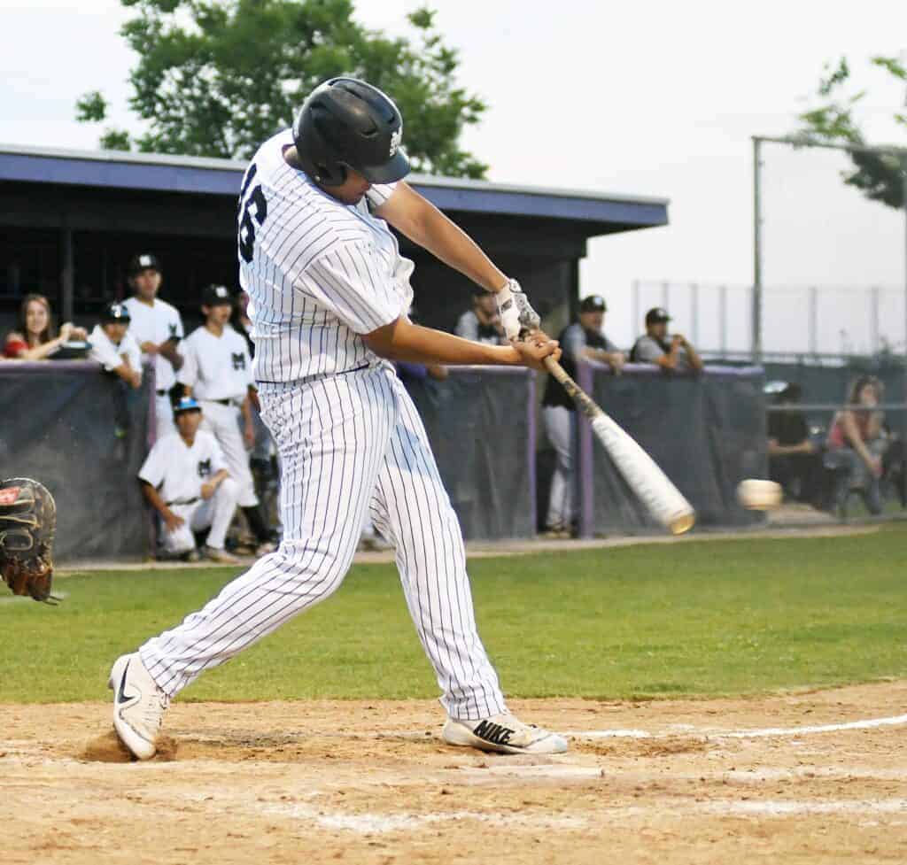 Photo - Madera South’s Carlos Gonzales reaches down for one of his two hits in Tuesday’s loss.