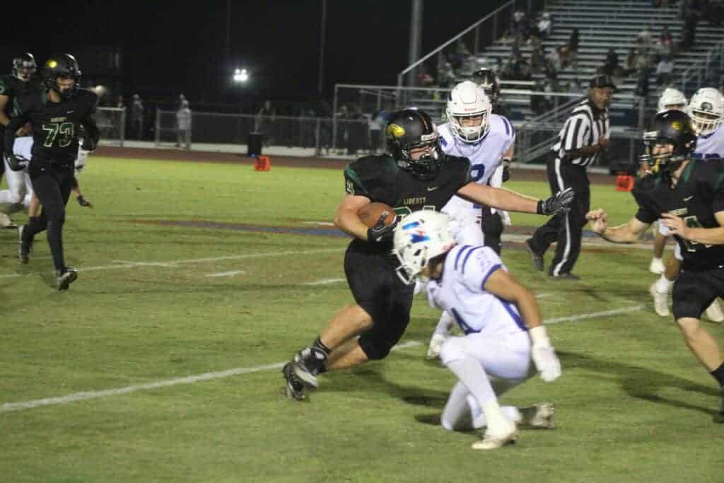 Photo - Liberty fullback cuts back against an Immanuel defender for extra yards during Friday’s victory over the Eagles. Howe finished with 97 yards rushing in the 49-19 win.