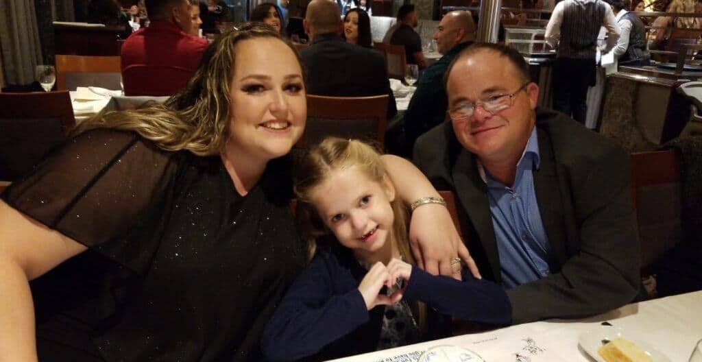 Photo - Kylee La Plant, center, shows love with her parents Brittney and Jason during a night out when Kylee was feeling better. Kylee suffers from Elhers Danlose Syndrome which causes her joints to have no cartilage, among other ailments.
