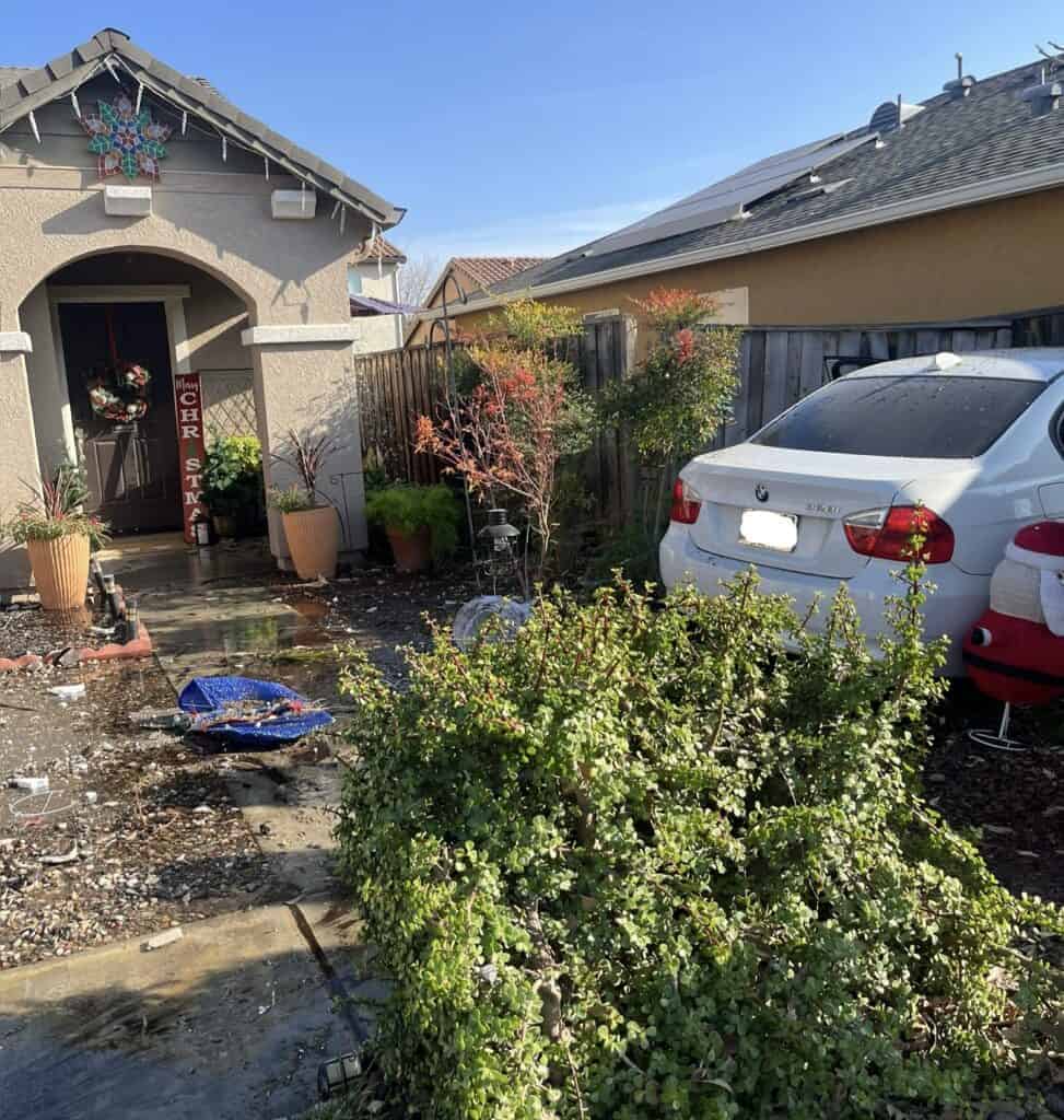 Photo - A car sits against a residence along Hacienda Street on Wednesday afternoon. The driver fled the scene, but was later apprehended and found to be under the influence at almost twice the legal limit.