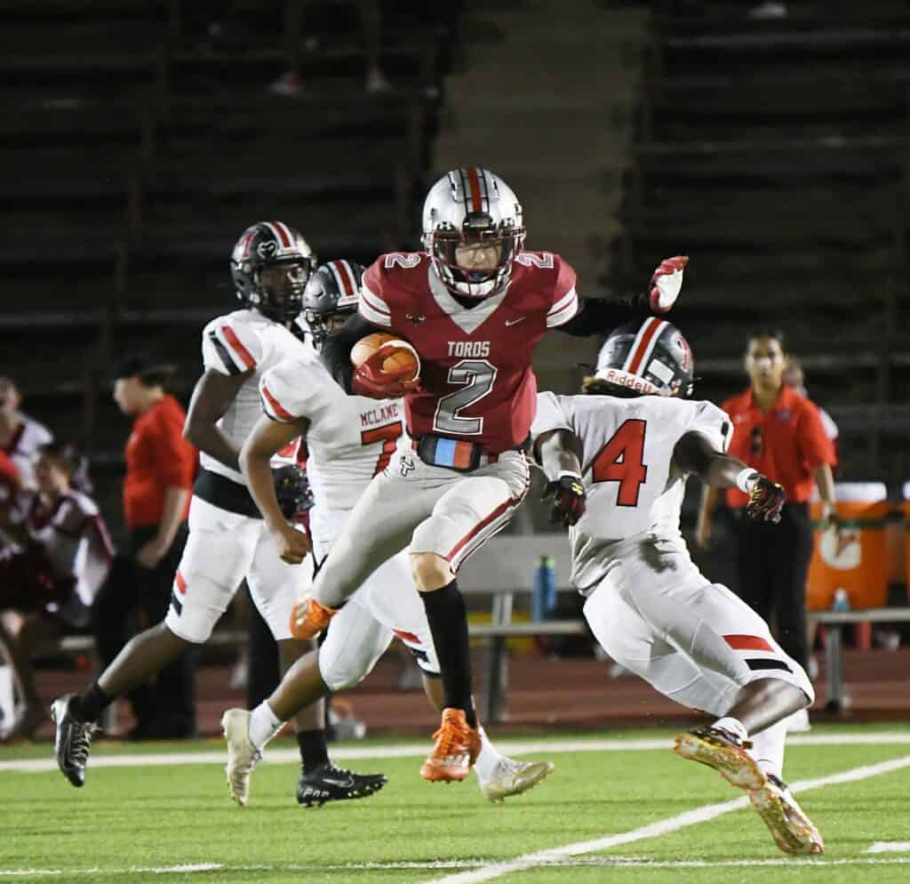 Photo - Matilda Torres receiver Jesus Moreno eludes a tackler during a 68-yard touchdown run that gave the Toros a 21-7 halftime lead during Friday’s victory over McLane.