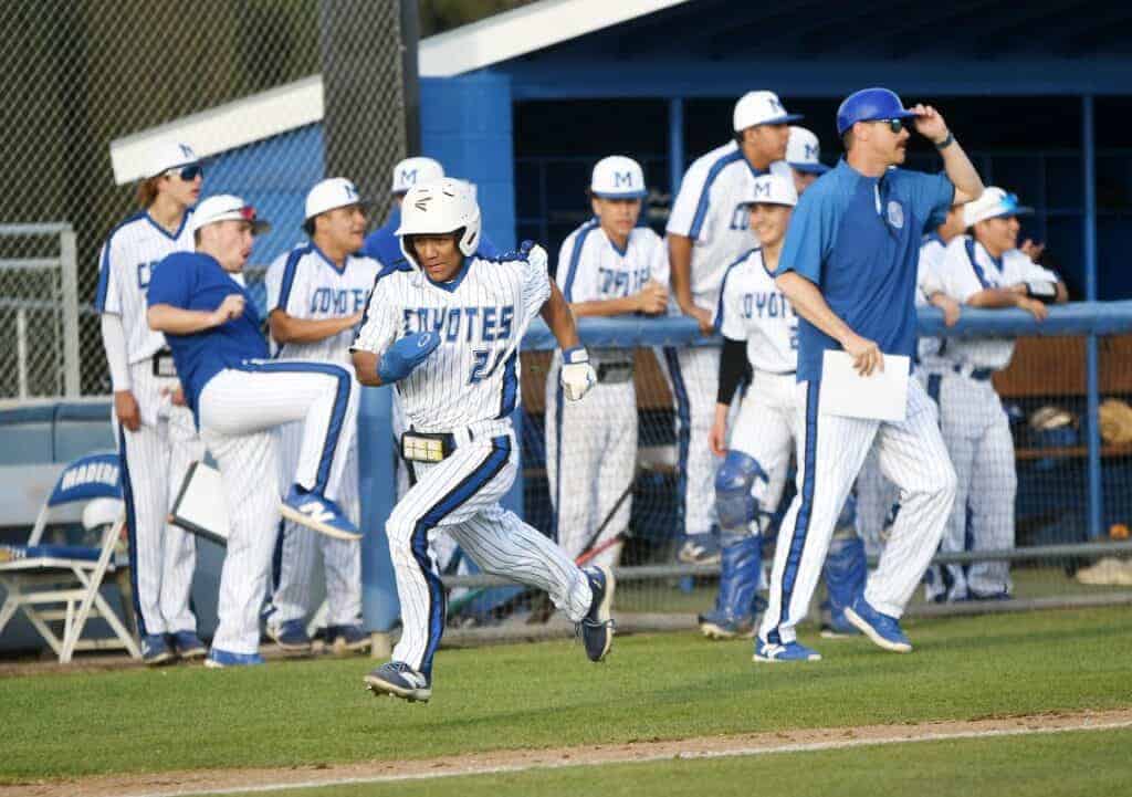 Photo - Madera’s Zach Sanchez races to the plate to score Madera’s second run in an 11-5 loss to the Liberty Patriots on Friday at Mel Parker Field. He hit a single and double in the loss.