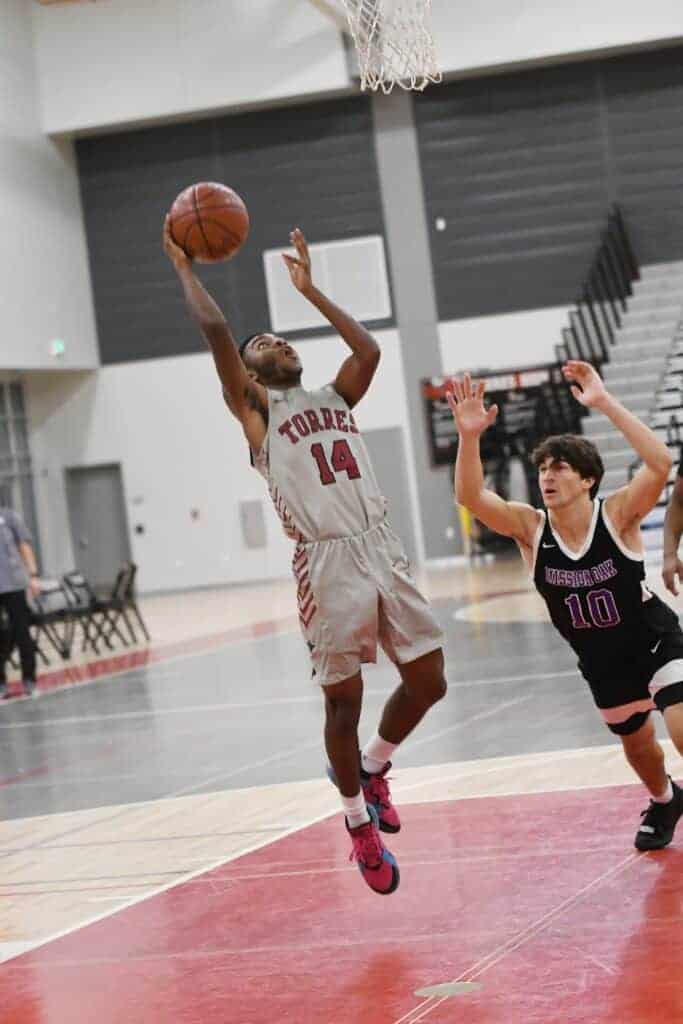 Photo - Matilda Torres’ Arturo Corona drives the lane to score two of his game-high 21 points in Thursday’s loss to the Mission Oak Hawks.