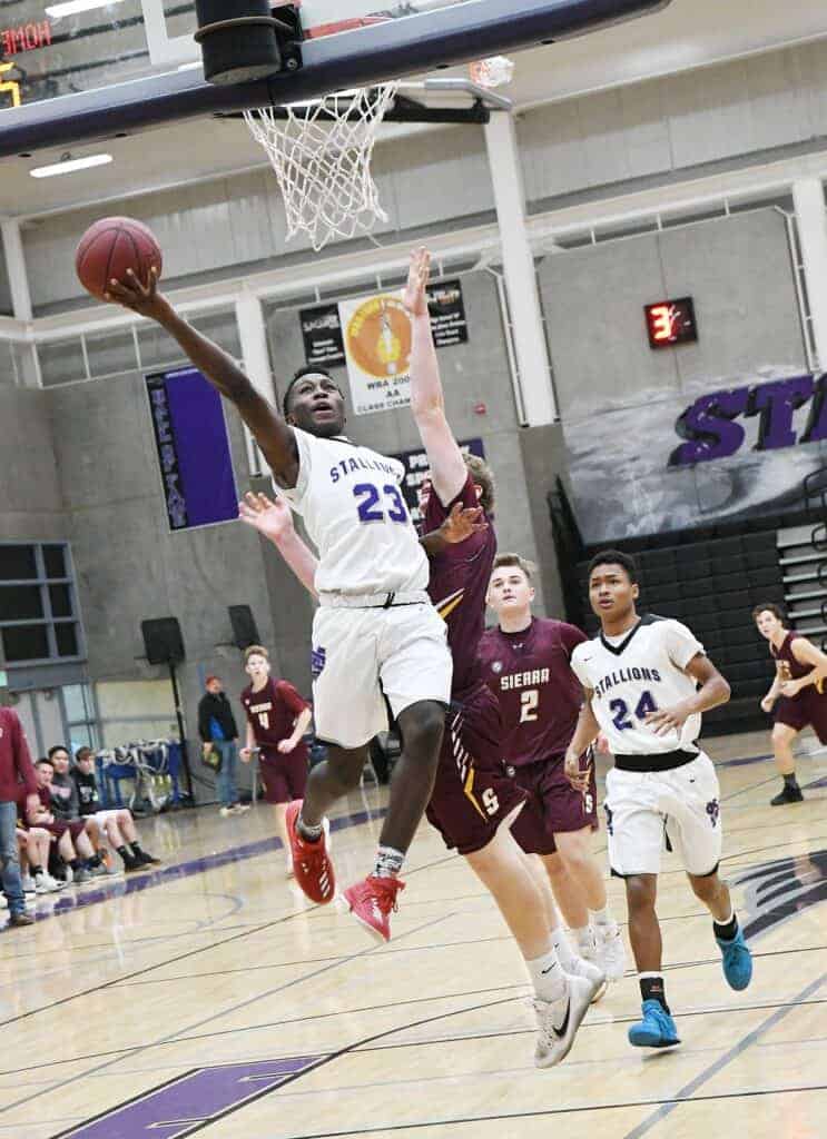 Photo - Madera South’s Hakeem Primes drives the lane for a layup during a victory over Sierra.