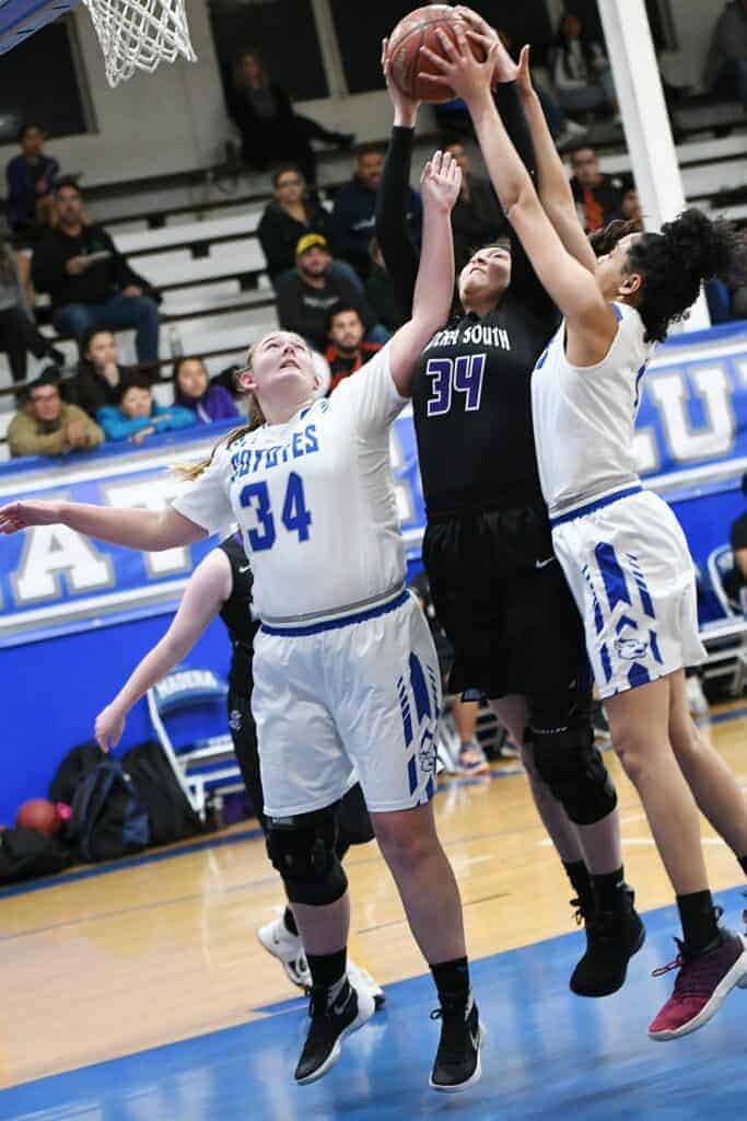 Photo - Madera South’s Arelis Chavez (34, middle) battles with Madera’s Madeleine McNeil (34) and BriAnn Houghton for a rebound during Tuesday’s victory over the Coyotes.