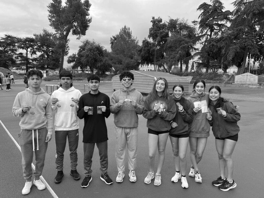 Photo - From left, Michael Pedro, Jonathan Garza, Jazir Alejandre, Josh Marchan, Mayce Atherton, Bianca Scott, Natalia Zambrano and Angela Garcia show off the medals they received from the Central Valley Relays held in Dinuba.