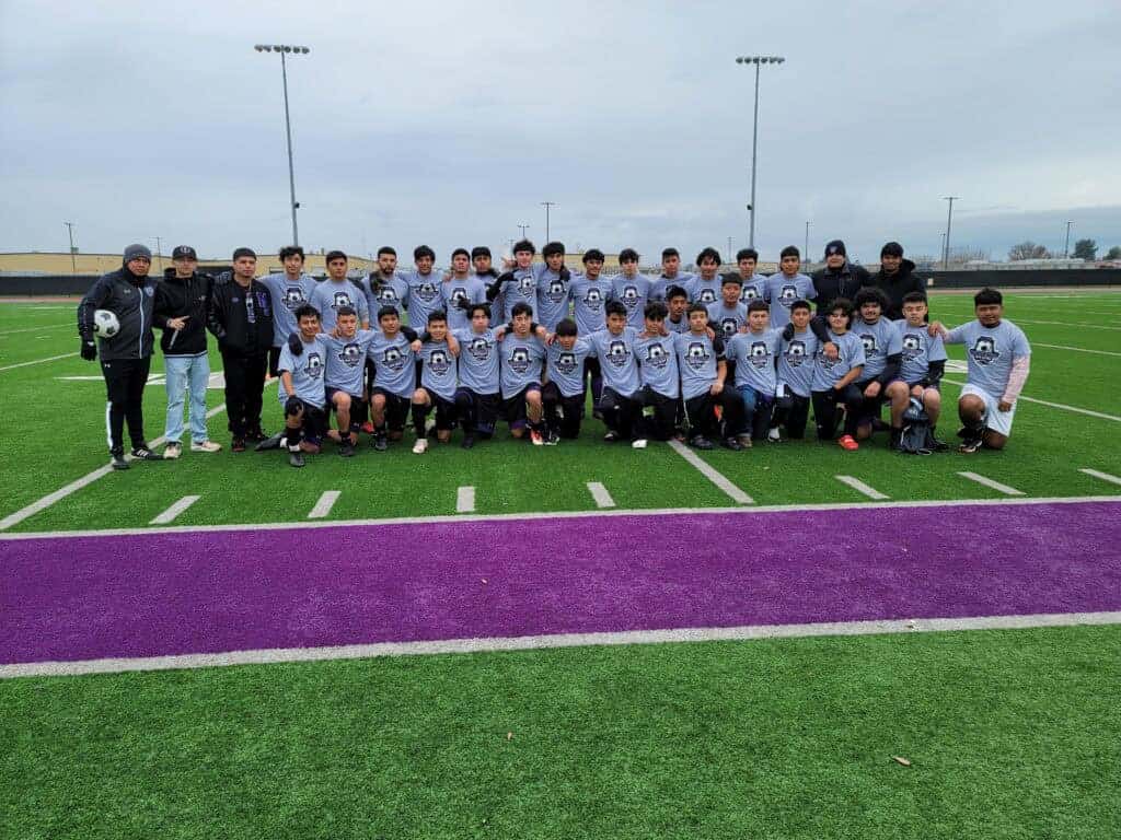 Photo - Members of the Madera South Stallions junior varsity and varsity boys soccer teams show off the new warm-up shirts they received from a donation by Come Up Kickz and owner Abraham Vasquez, a former Stallions’ soccer player.