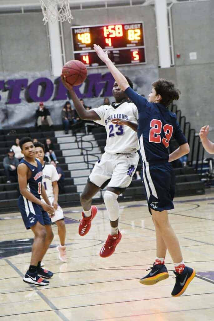 Photo - Madera South’s Hakeem Primes drives to the lane to score two of his team-high 18 points in a loss to San Joaquin Memorial on Tuesday.