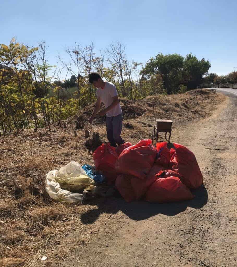 Photo - Collin Molina and bags of trash.